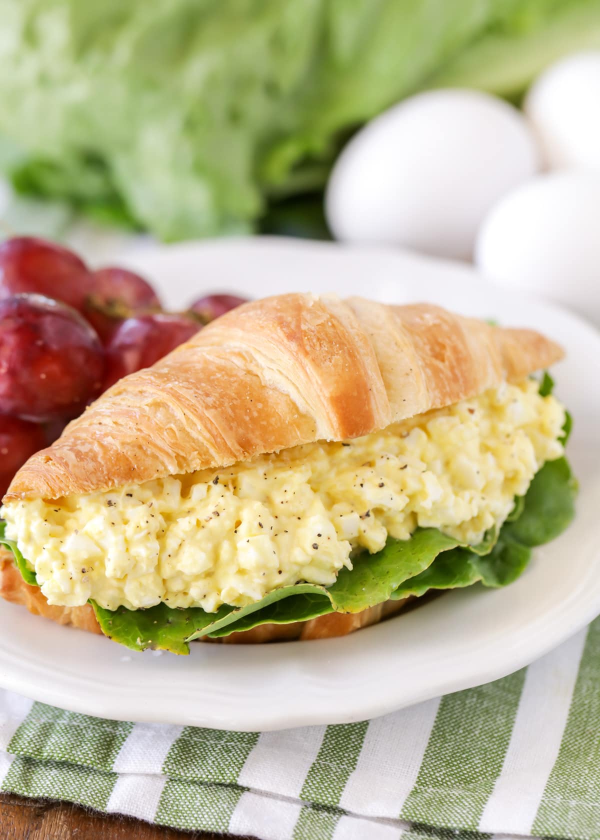 How to make egg salad served on a croissant with grapes.