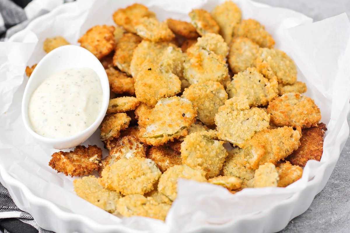 Deep Fried Pickles on a platter with ranch dipping sauce.