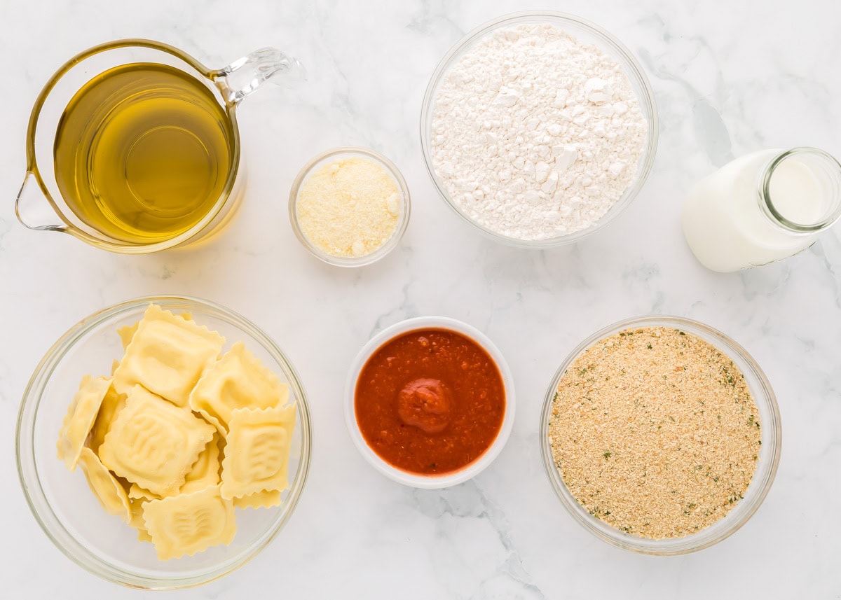 Ingredients for fried ravioli on a kitchen counter.