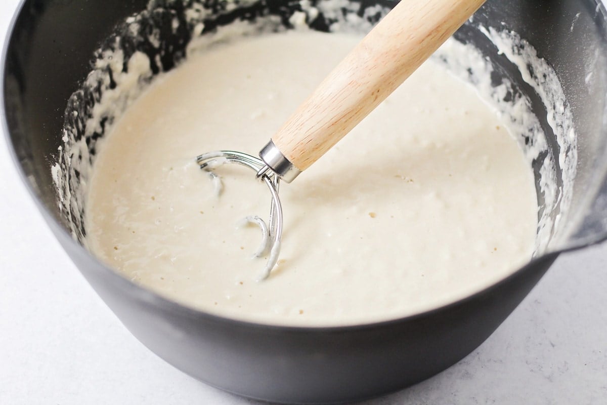 Mixing Italian bread dough in a grey bowl.