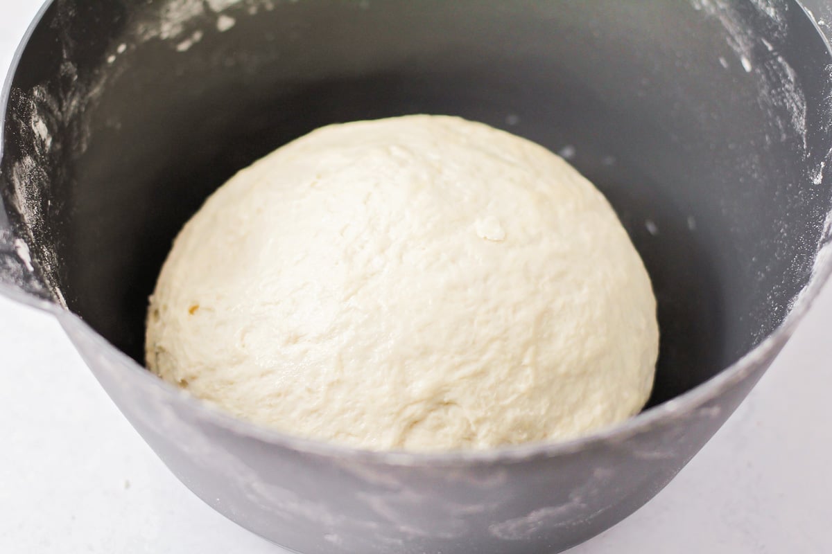 Mixing Italian bread dough in a grey bowl.