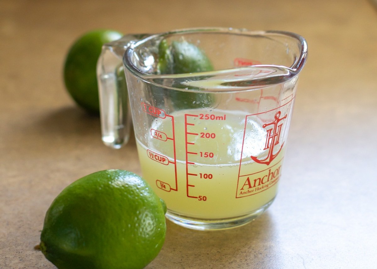 Fresh squeeze lime juice in a measuring cup for making key lime pie bars.