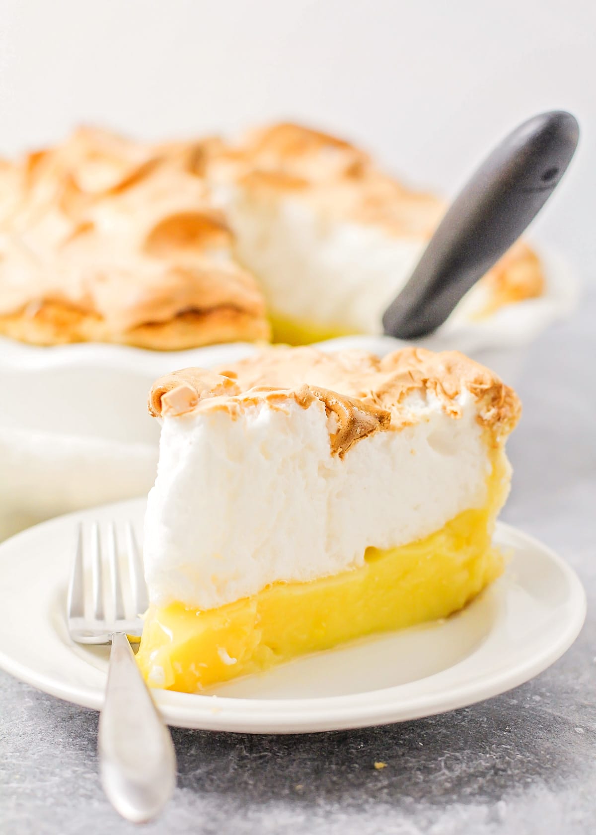 A slice of lemon meringue pie, showing the layers.