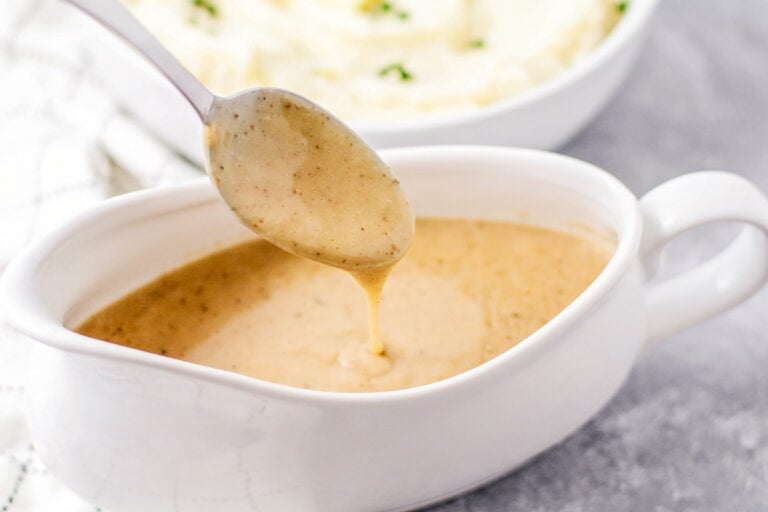 Mashed Potato gravy recipe being spooned out of gravy boat.