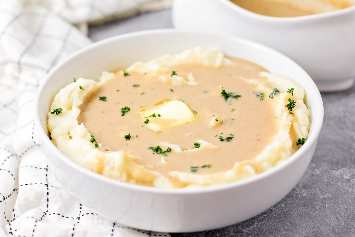 Mashed potato gravy on top of a bowl of mashed potatoes.