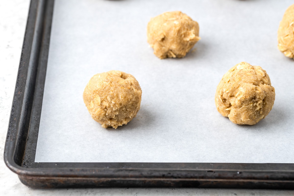 Easy oatmeal cookies dough balls on a sheet ready to cook.