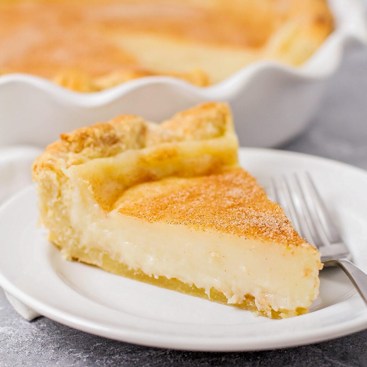 A slice of sugar cream pie recipe on a white plate.