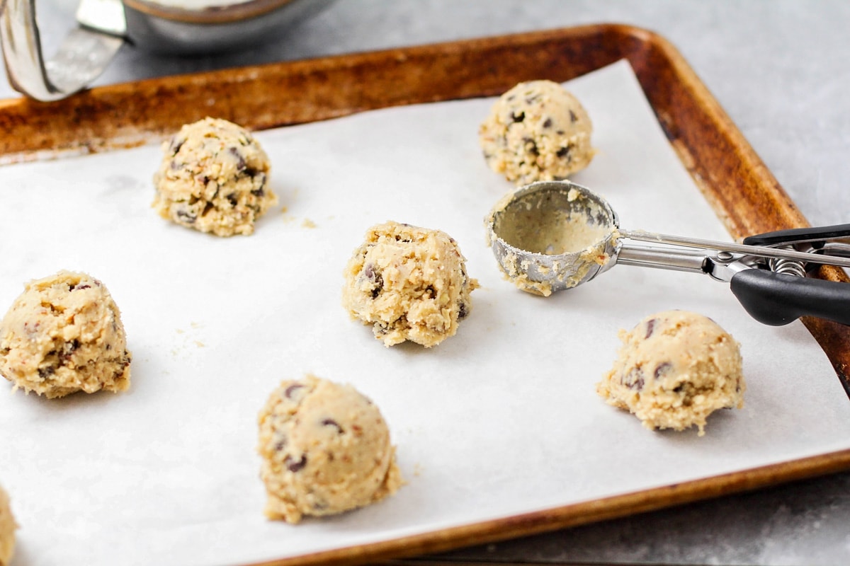 Nestle chocolate chip cookie balls on a sheet pan.