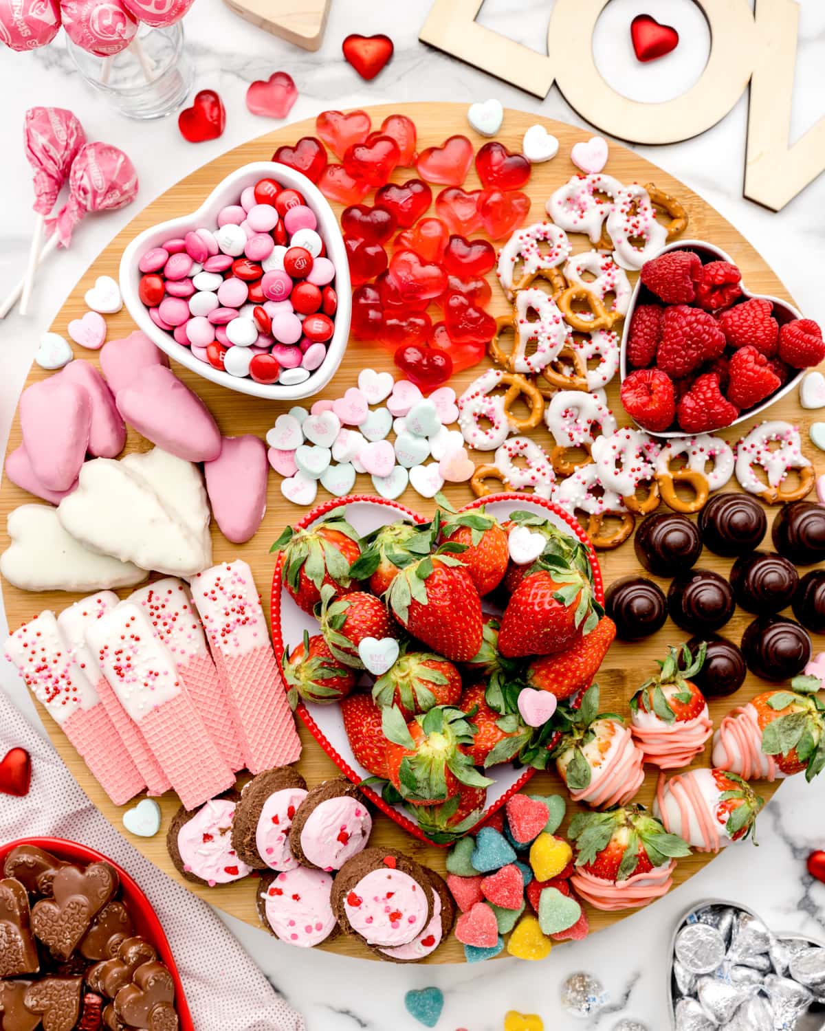 Close up of a valentine's charcuterie board filled with sweet treats.