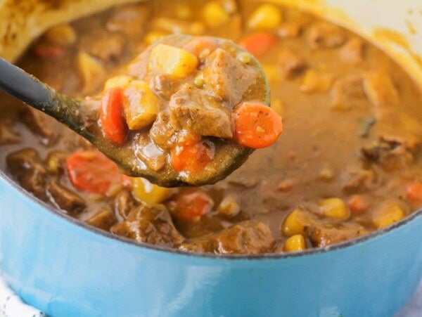 Beef stew recipe in a blue dutch oven.