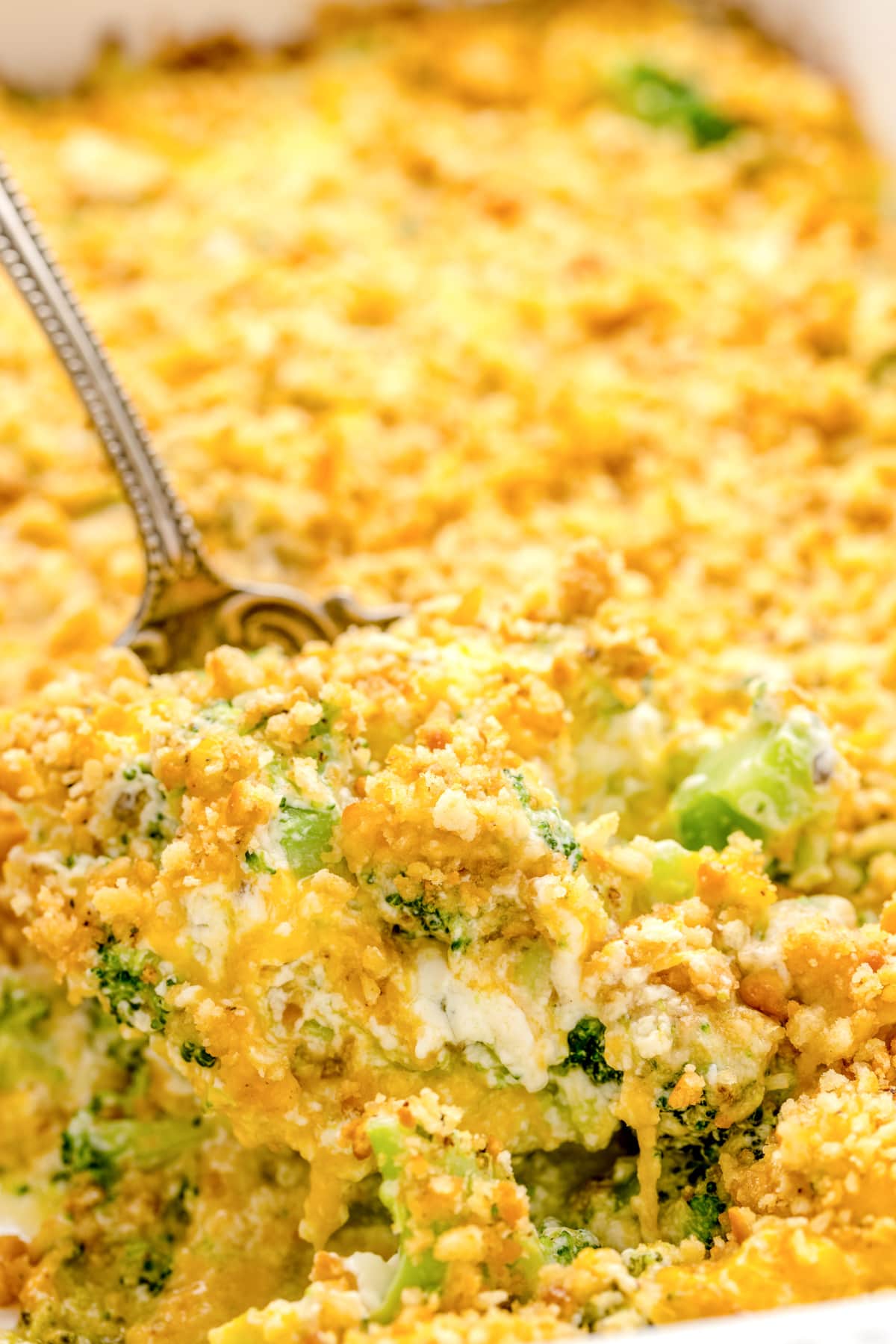 Close up of a scoop of the broccoli cheese casserole.