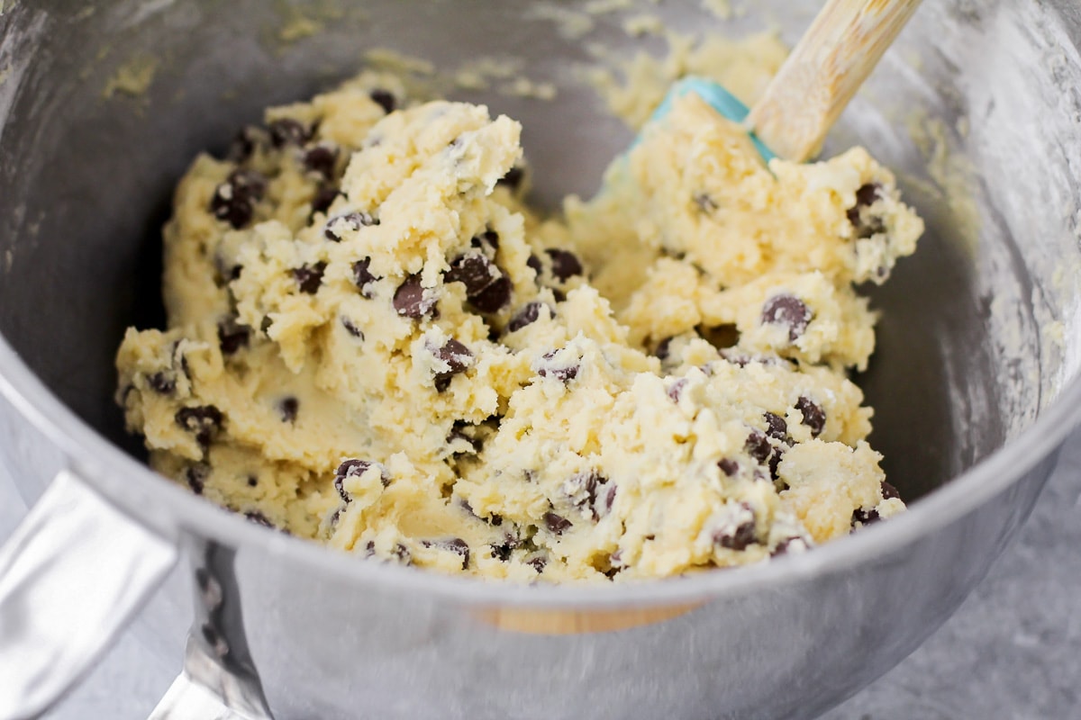 Mixing cookie dough batter with chocolate chips.