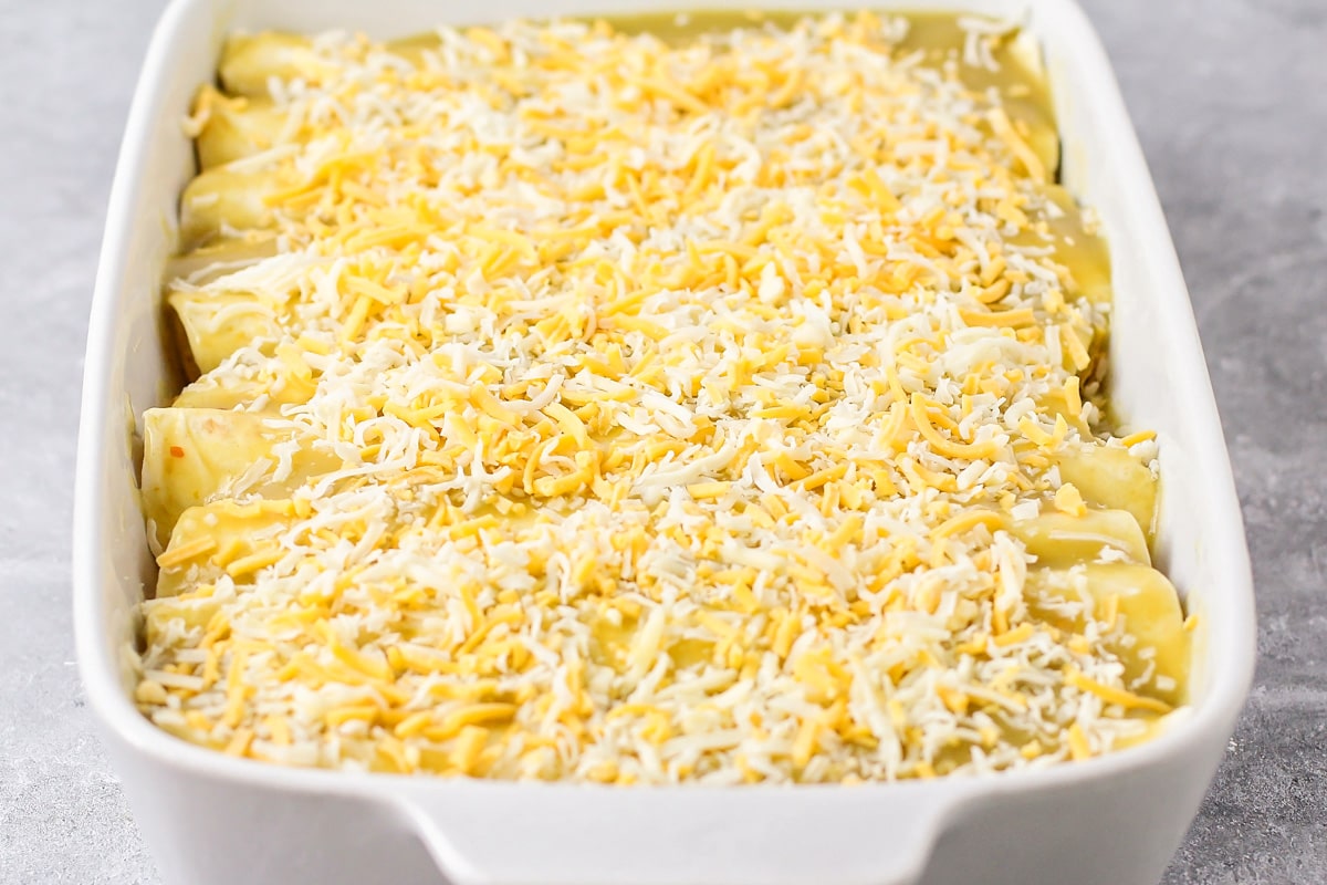 Rolled and sauced tortillas topped with shredded cheese.