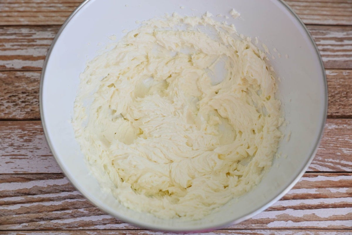 Cream cheese and butter mixture in a white mixing bowl.