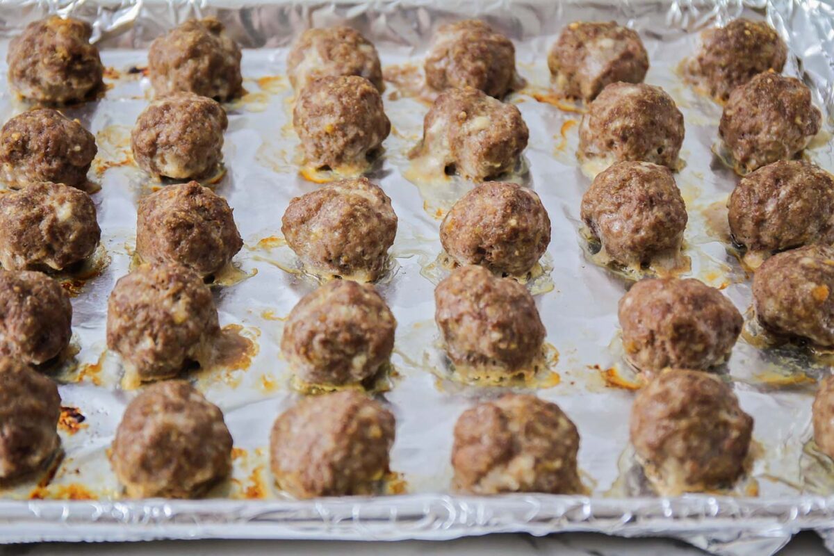 Homemade meatballs baked on jelly roll pan.