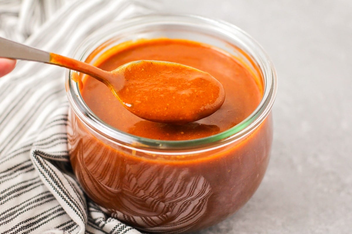 Red enchilada sauce recipe in a glass jar.