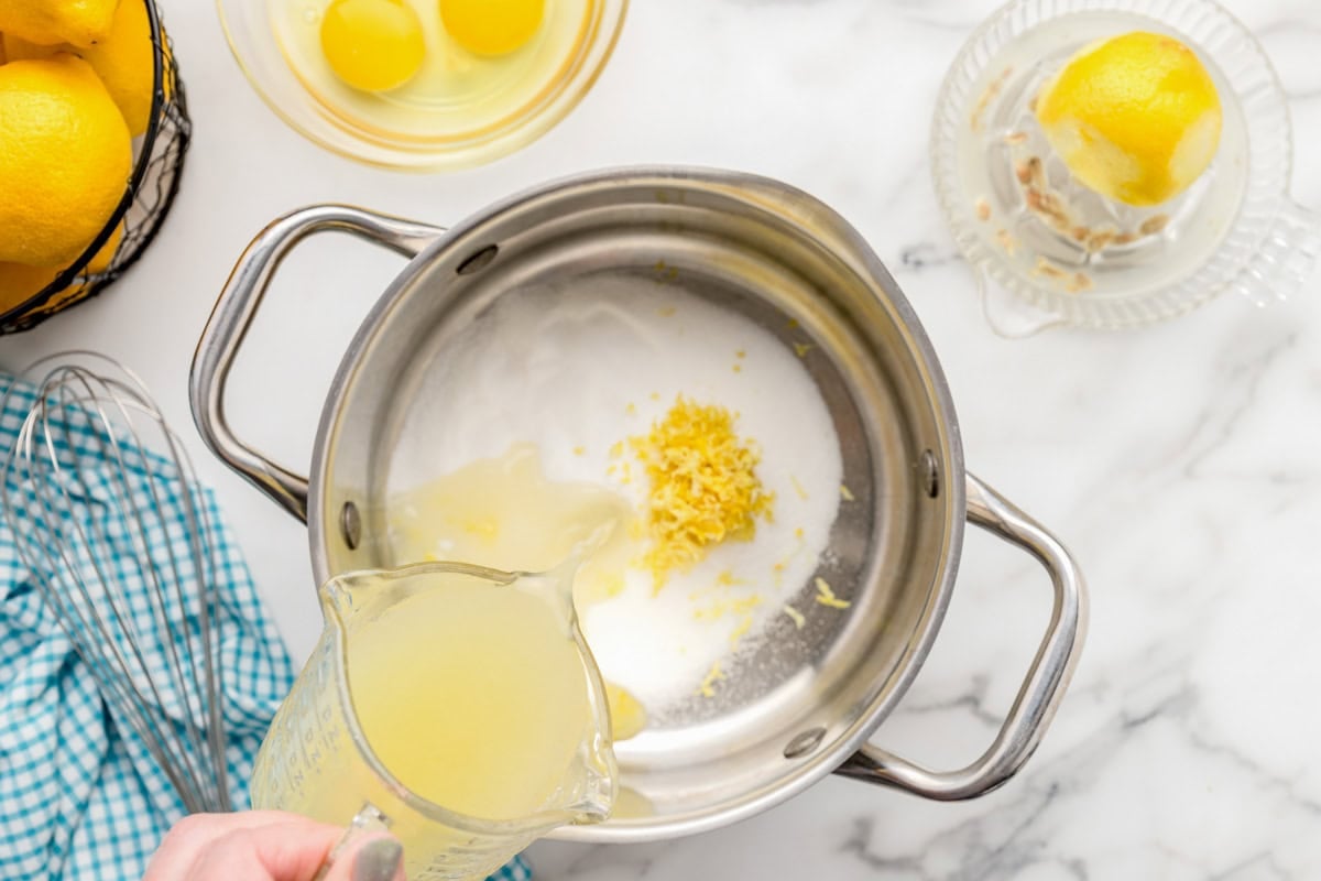 Adding sugar, zest and more to a pan.