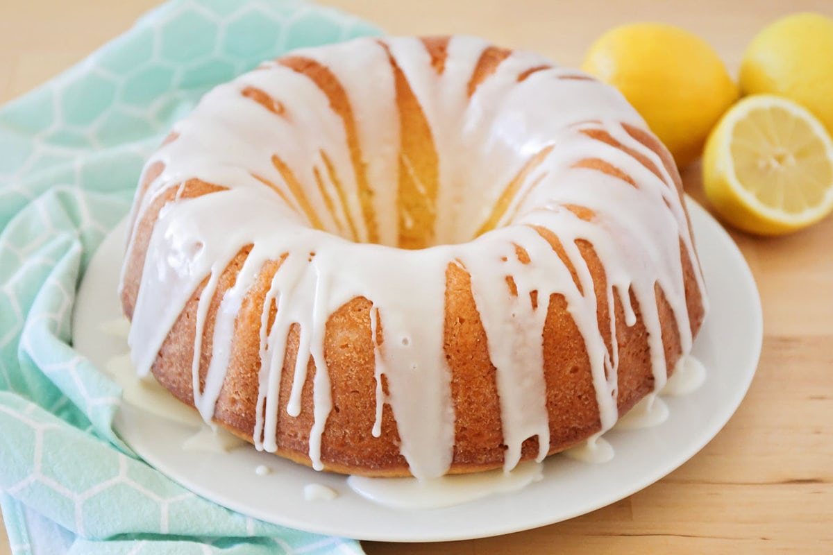 Lemon pound cake with lemon glaze on a white plate.