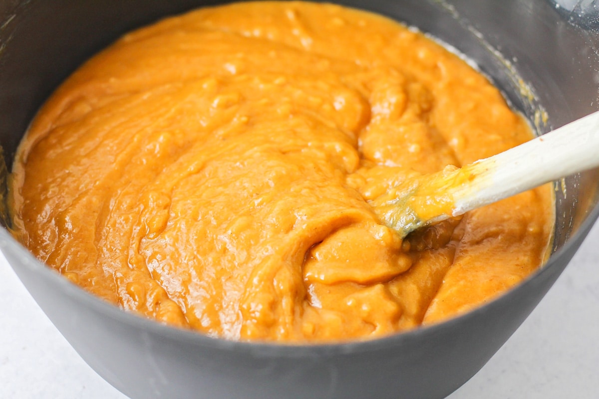 Pumpkin batter mixed in a grey bowl.