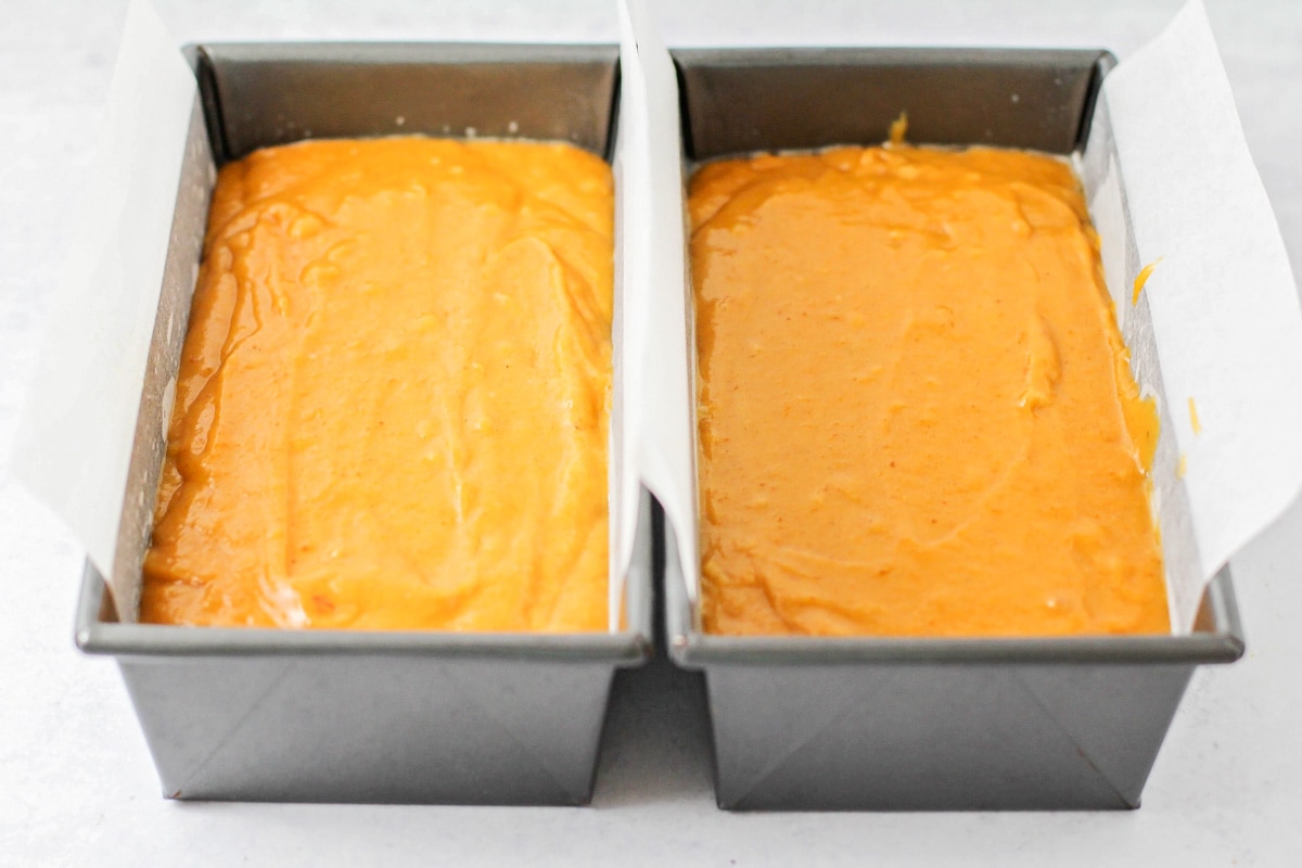 Pumpkin batter divided into two loaf pans.