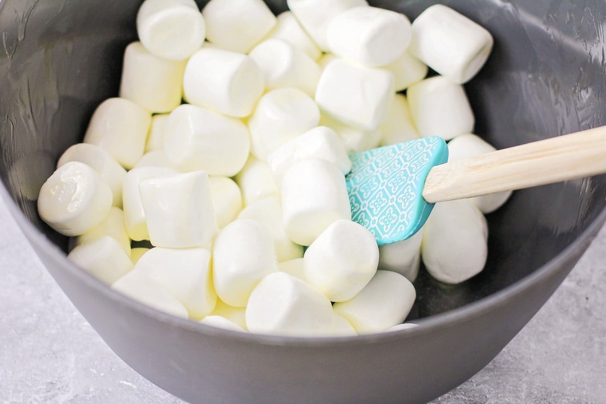 Marshmallows and melted butter in a grey bowl.