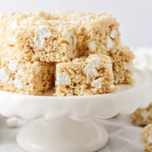 Several rice krispie treat recipe slices on a white platter.
