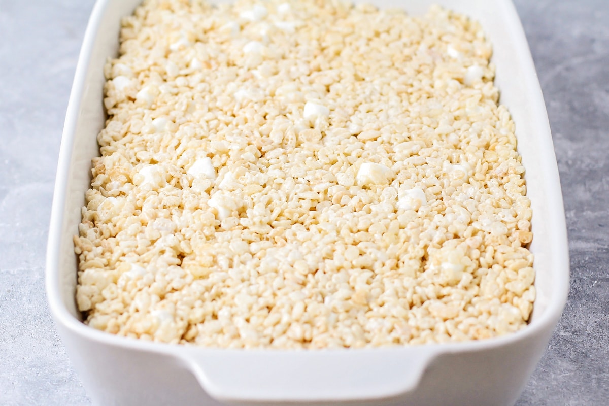 A white baking dish filled with with rice krispie treats recipe.