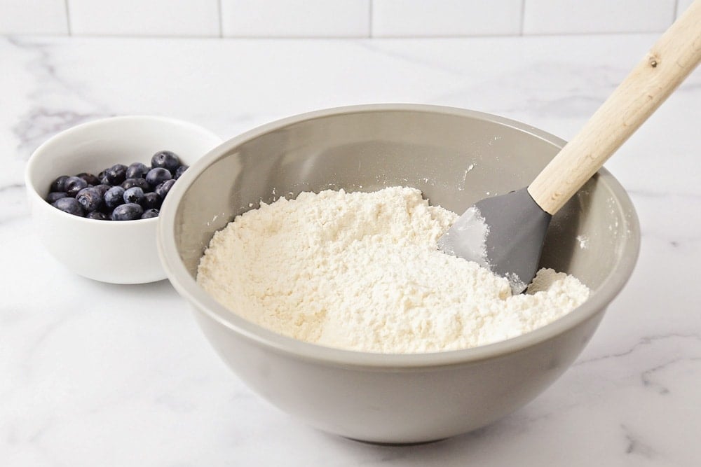 Mixing dry ingredients for scones recipe in a grey mixing bowl. 