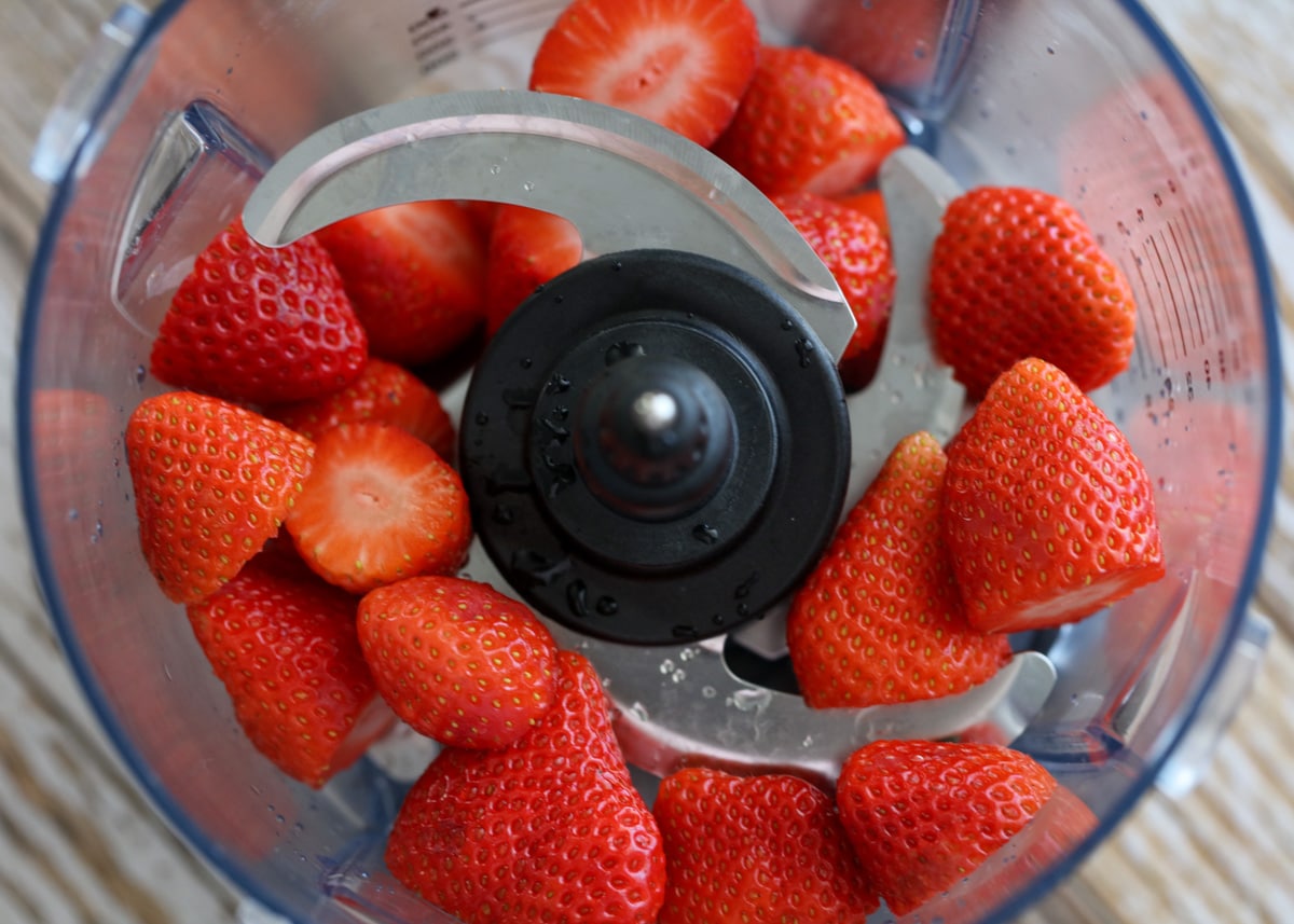 Fresh strawberries in a food processor. 