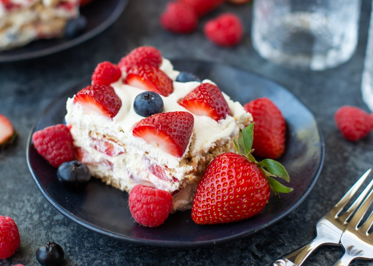 Slice of strawberry icebox cake on plate.