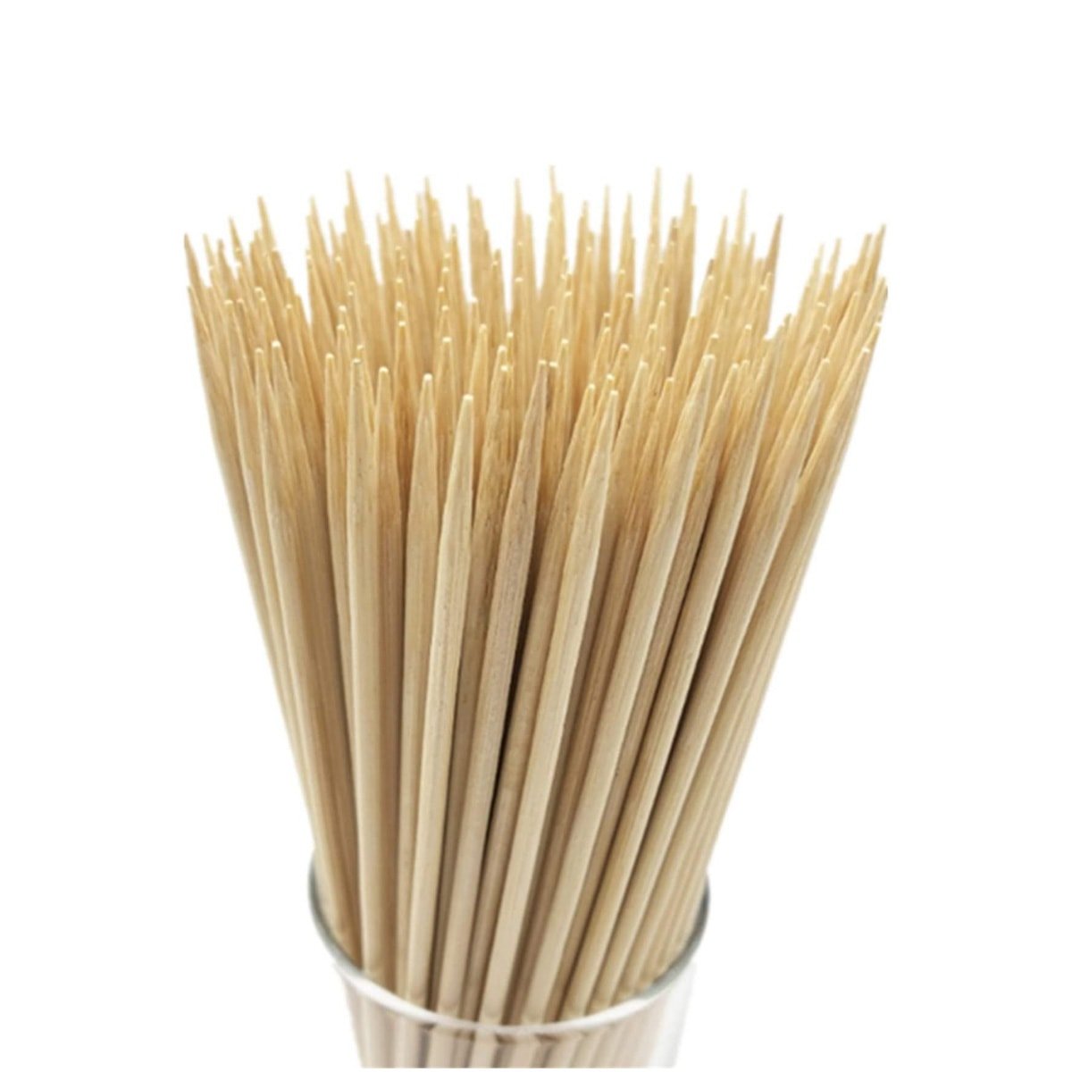 Several bamboo skewers in a glass vase.