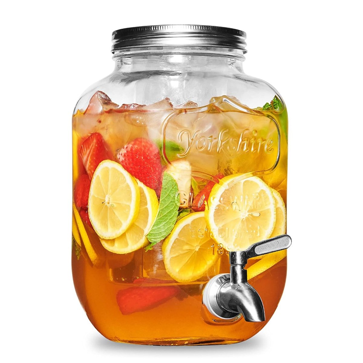 A glass drink dispenser with a stainless steel lid and dispenser filled with ice tea and sliced fruit.