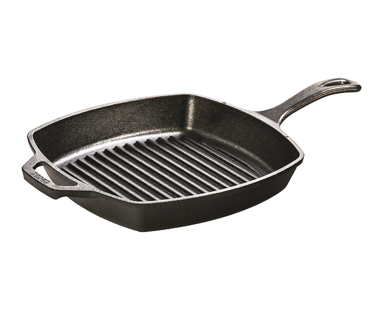 A black cast iron grill pan with slotted grooves for making grill marks.