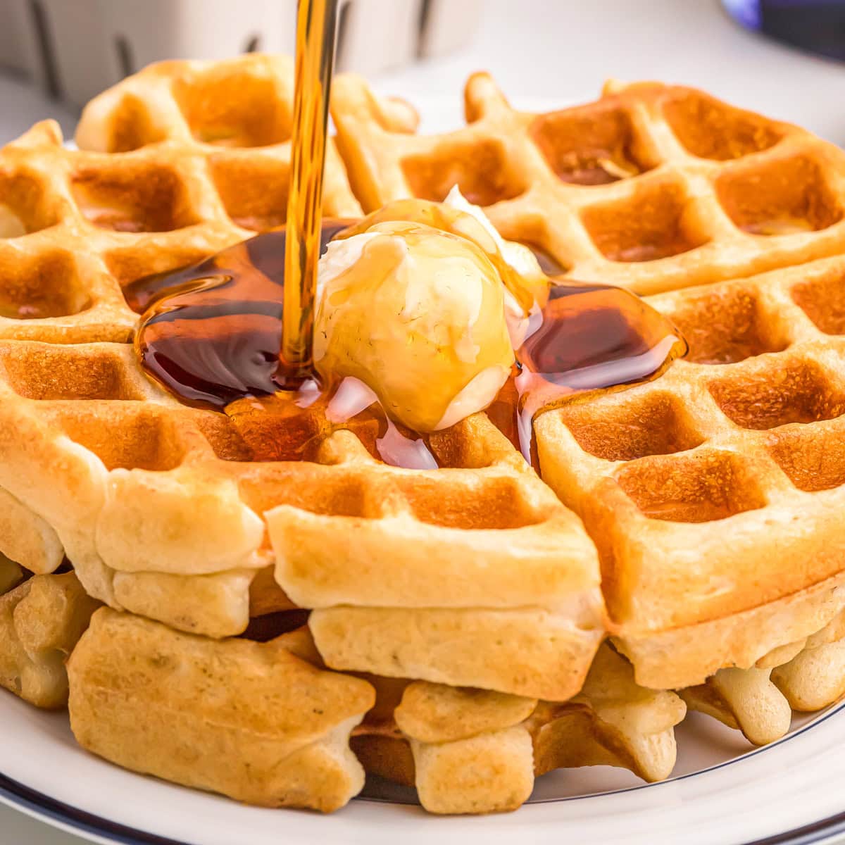 Bisquick waffle recipe with butter and syrup on top.