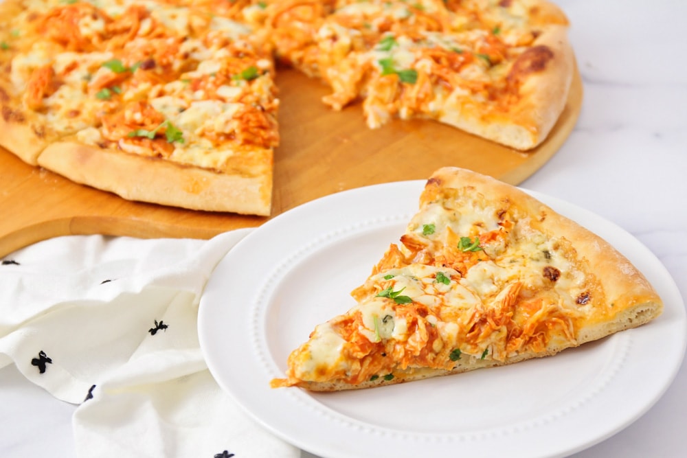 Slice of Buffalo Chicken pizza on white plate.