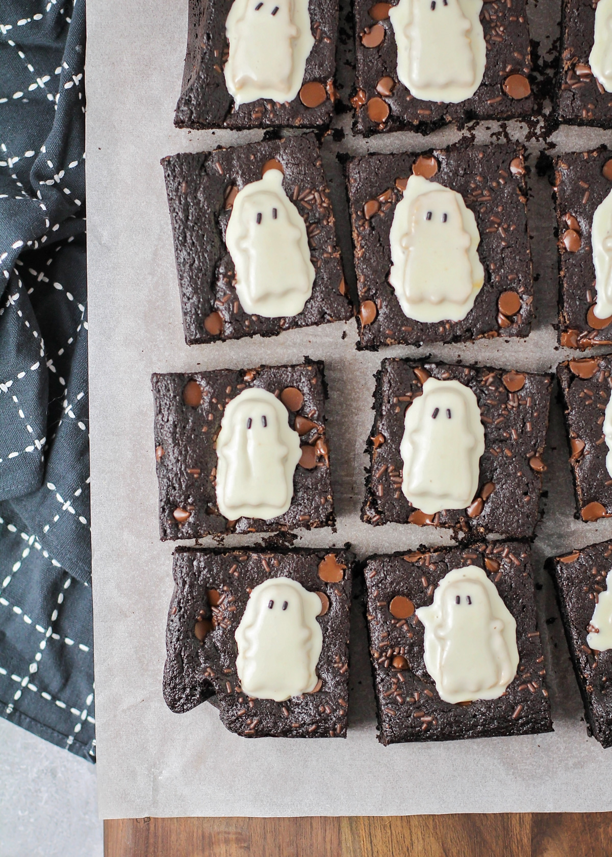Close up of cut Halloween brownies topped with Reese's Ghosts.
