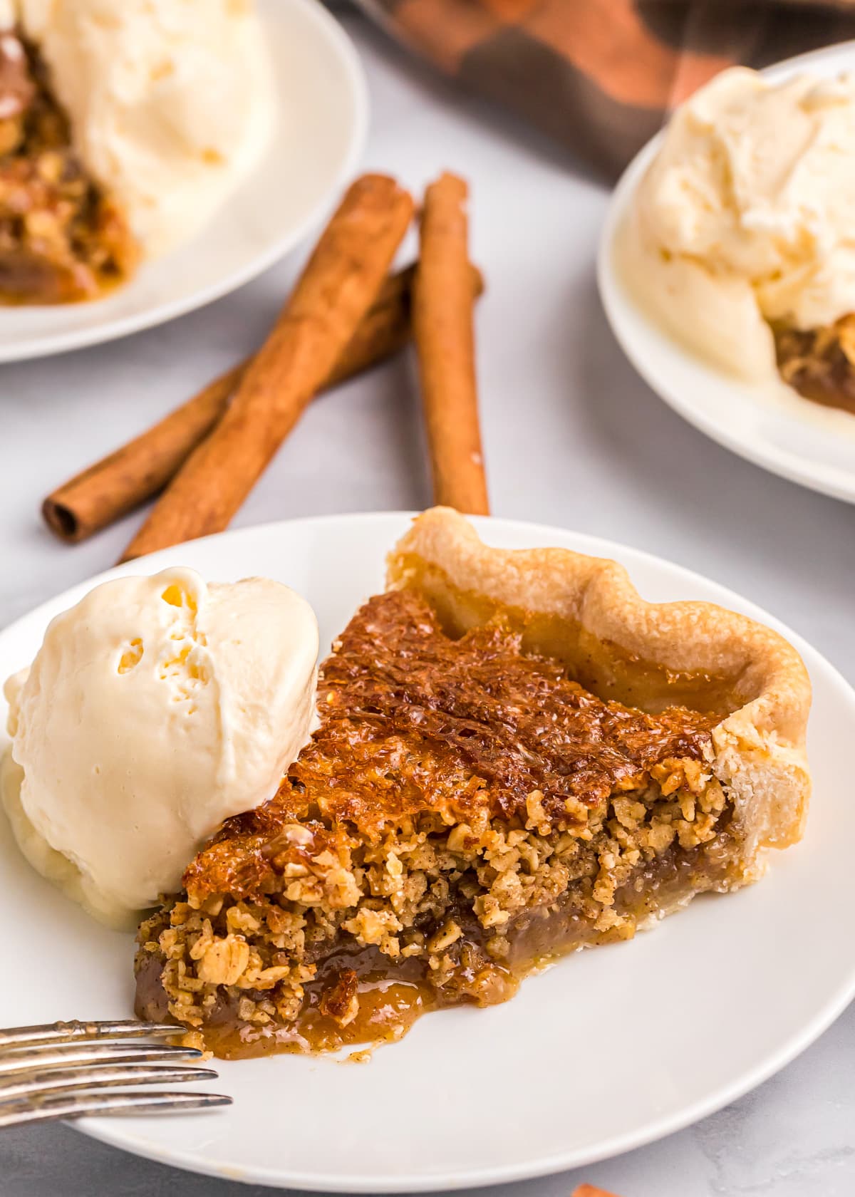 A slice of oatmeal pie served with vanilla ice cream.