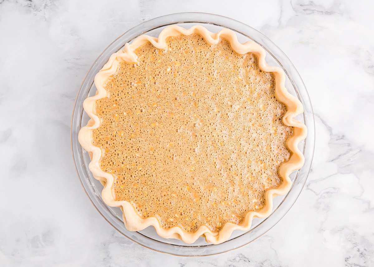 Oatmeal filling poured into a pie crust.