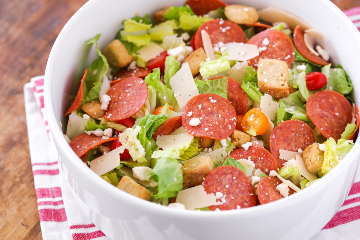 Pizza Salad in bowl with tomatoes, pepperoni, cheese and croutons.