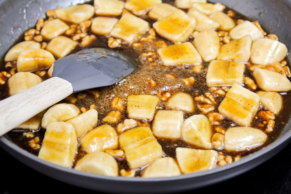 Bananas foster cooking in skillet.