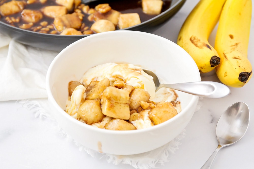 Bananas foster recipe served on top of vanilla ice cream.