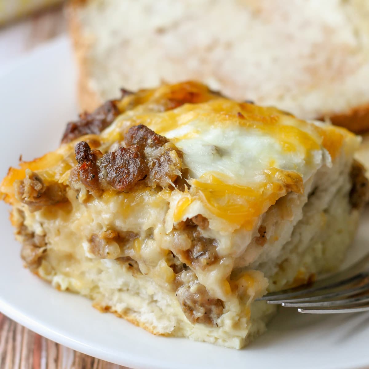 Breakfast casserole slice on a white plate.