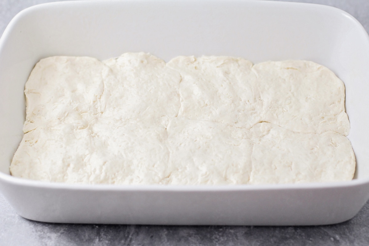 Biscuits pressed into the bottom of a baking dish.