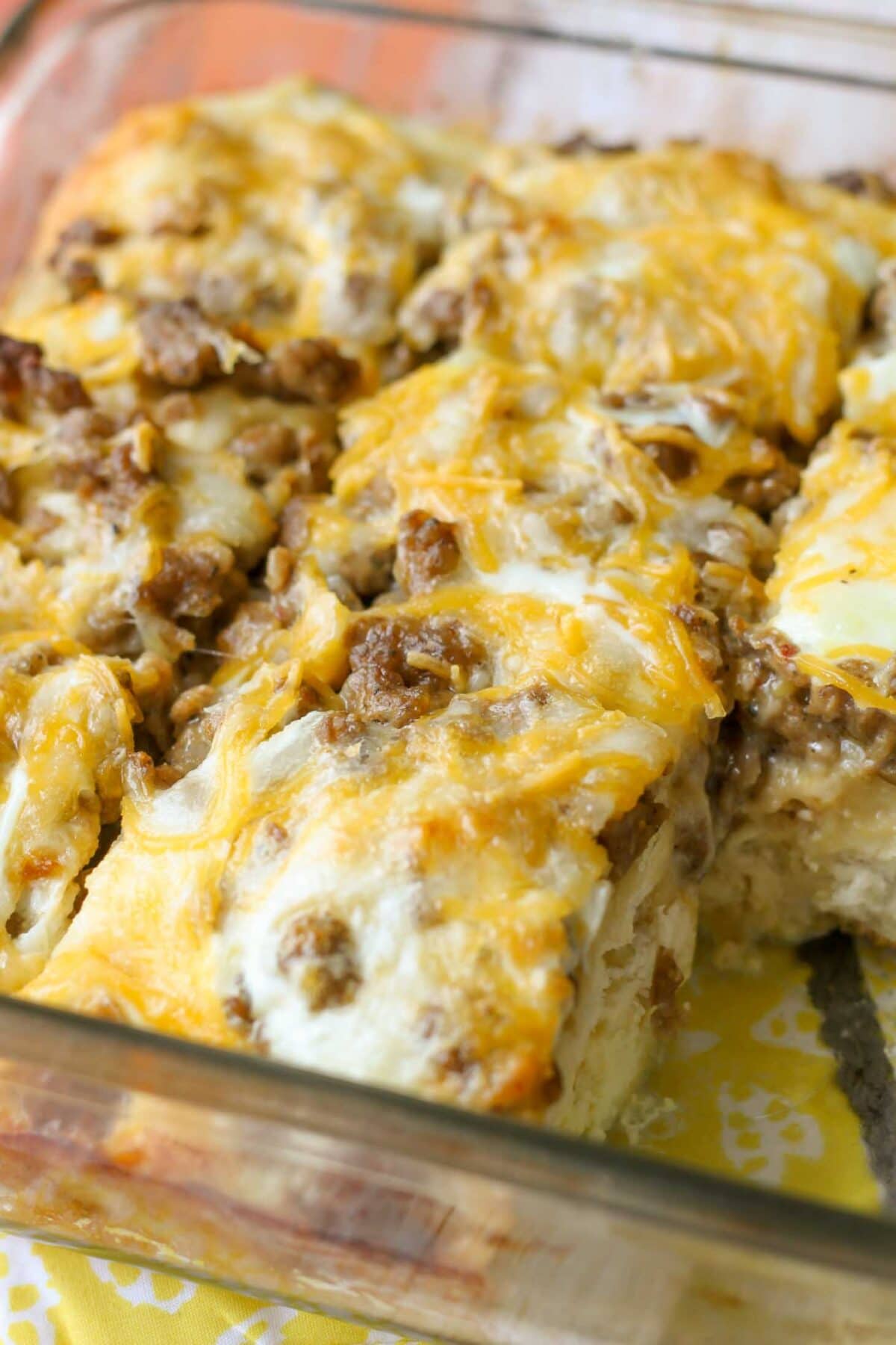 Close up of breakfast casserole slices in glass baking dish.