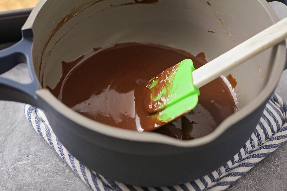 Mixing brownie batter in a grey bowl.