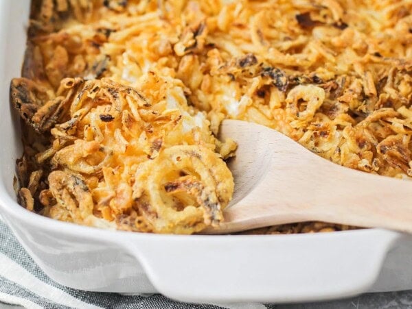 Tater Tot Casserole being scooped out of baking dish.