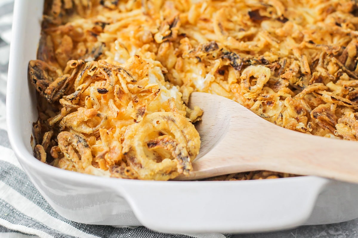 Close up of cheesy tater tot casserole topped with fried onions.