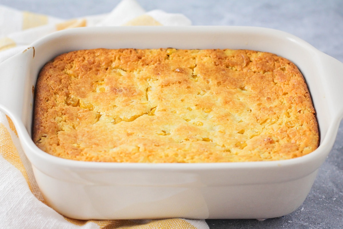 Corn bread mixture baked in a white baking dish.