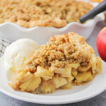 A slice of dutch apple pie with ice cream.