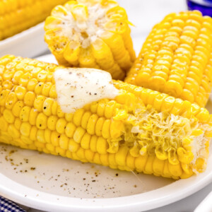Microwave corn on the cob topped with butter and pepper.